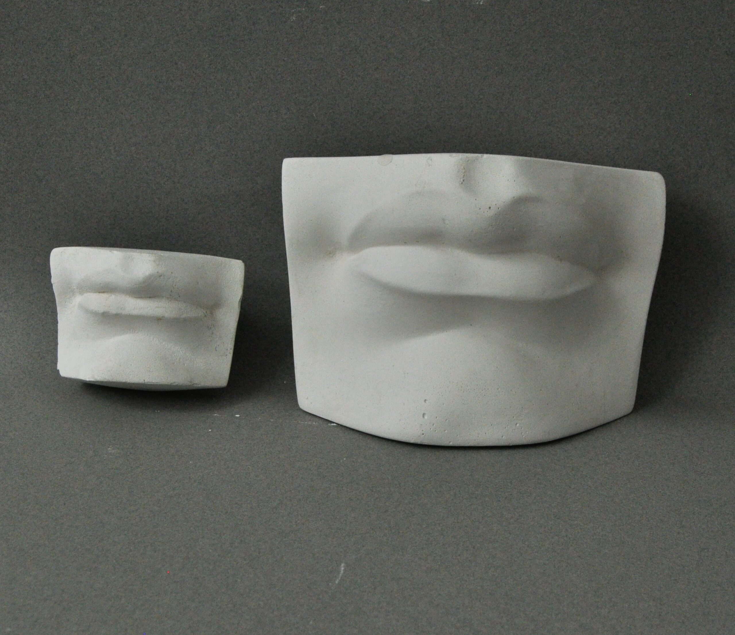 Comparison of the small and big plaster cast of Michelangelos David mouth from the front, used in traditional drawing courses